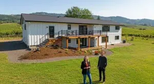Home buying consultation in Oregon with buyers viewing a McMinnville property near vineyards.